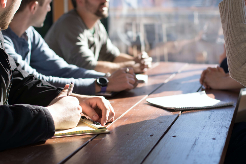 People working with each other at a board table